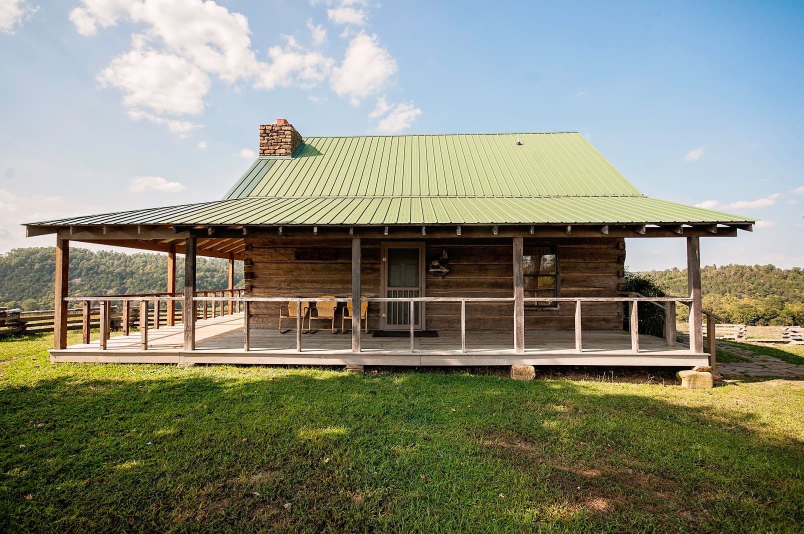 Nostalgic pioneer log cabin showcases Ozark family heritage and traditions.
